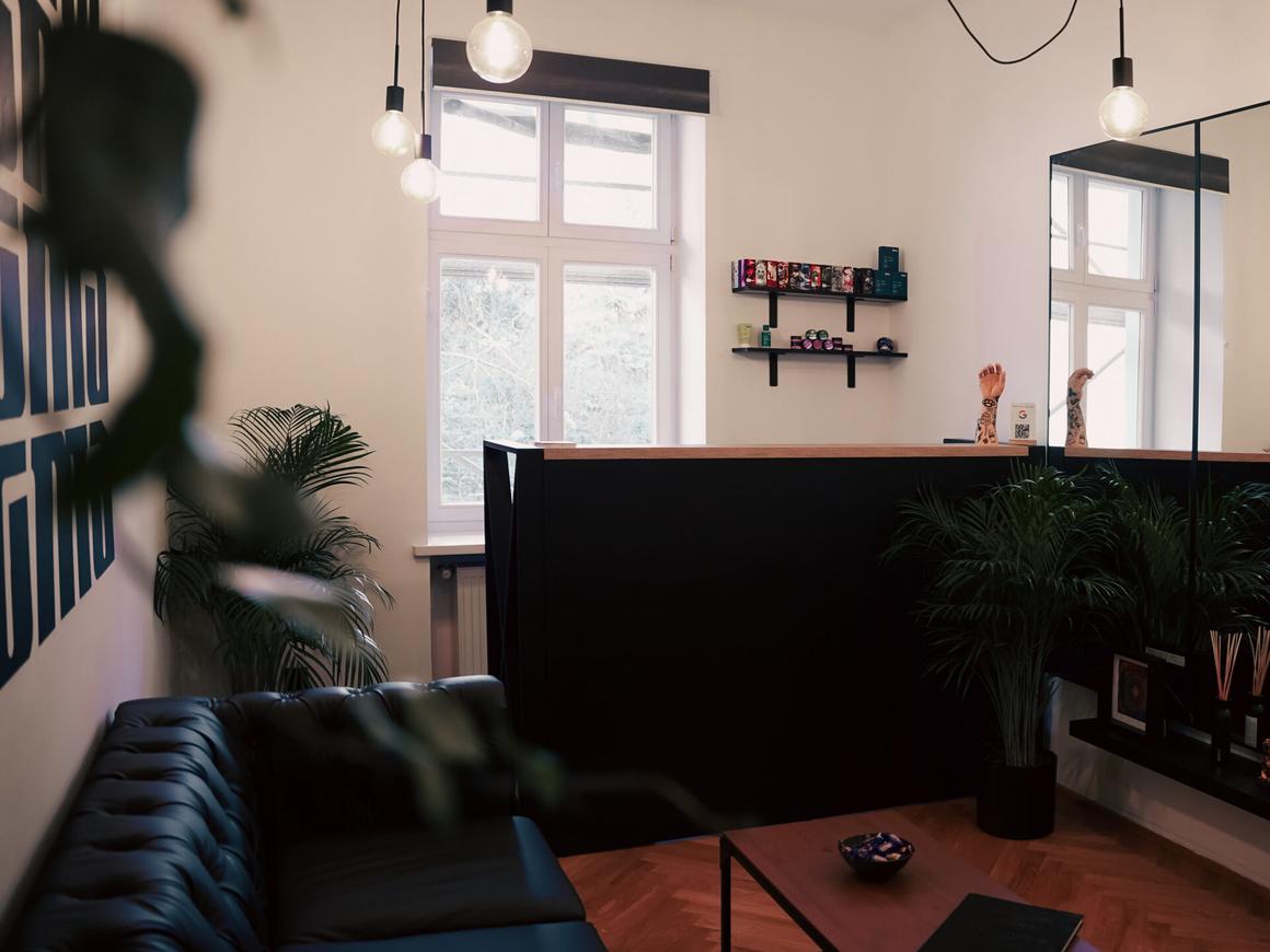 Reception and waiting area with a sofa and plants